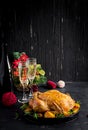 Baked turkey or chicken. The Christmas table is served with a turkey, decorated with bright tinsel. Fried chicken, table setting. Royalty Free Stock Photo