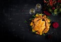 Baked turkey or chicken. The Christmas table is served with a turkey, decorated with bright tinsel. Fried chicken. Table setting. Royalty Free Stock Photo