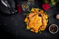 Baked turkey or chicken. The Christmas table is served with a turkey, decorated with bright tinsel. Fried chicken. Table setting. Royalty Free Stock Photo