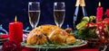 Baked turkey. Christmas dinner. The Christmas table is served with a turkey, decorated with bright tinsel and candles. Fried Royalty Free Stock Photo