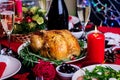 Baked turkey. Christmas dinner. The Christmas table is served with a turkey, decorated with bright tinsel and candles. Fried Royalty Free Stock Photo