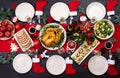 Baked turkey. Christmas dinner. The Christmas table is served with a turkey, decorated with bright tinsel and candles. Fried