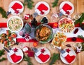 Christmas dinner. The Christmas table is served with a turkey, decorated with bright tinsel and candles Royalty Free Stock Photo