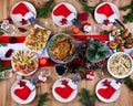 Christmas dinner. The Christmas table is served with a turkey, decorated with bright tinsel and candles Royalty Free Stock Photo