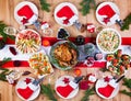 Christmas dinner. The Christmas table is served with a turkey, decorated with bright tinsel and candles Royalty Free Stock Photo