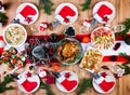 Christmas dinner. The Christmas table is served with a turkey, decorated with bright tinsel and candles. Royalty Free Stock Photo