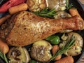 Baked turkey leg with vegetables, carrots, peppers, potatoes vegetables. close-up