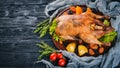 Baked turkey with vegetables and spices. Thanksgiving day. Goose chicken grill. On a wooden background. Royalty Free Stock Photo