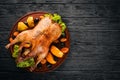 Baked turkey with vegetables and spices. Thanksgiving day. Goose chicken grill. On a wooden background. Royalty Free Stock Photo