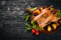 Baked turkey with vegetables and spices. Thanksgiving day. Goose chicken grill. On a wooden background. Royalty Free Stock Photo