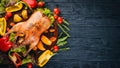 Baked turkey with vegetables and spices. Thanksgiving day. Goose chicken grill. On a wooden background. Royalty Free Stock Photo