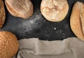 baked various loaves of bread on a black background, empty space