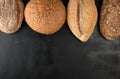 baked various loaves of bread on a black background