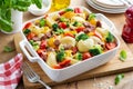 Baked vegetable and sausages lumaconi pasta in white baking dish