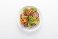 Baked vegetables - broccoli, tomato, mushrooms, peppers, eggplant, zucchini and red onions in a white plate on a light background Royalty Free Stock Photo