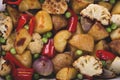 Baked vegetables in oven rustic potatoes cauliflower pepper vegetarian dish close up