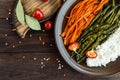 Baked vegetables (asparagus beans and carrot), boiled rice and rye croutons. Royalty Free Stock Photo