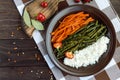 Baked vegetables (asparagus beans and carrot), boiled rice and rye croutons. Royalty Free Stock Photo