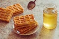 Baked waffles and organic sweet honey for breakfast Royalty Free Stock Photo