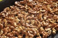 Baked walnut kernels on a black backing tray close-up. Walnut background