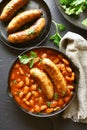 Baked white beans in tomato sauce and grilled sausages Royalty Free Stock Photo