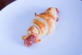 Baked wrapped sausage with cheese, ketchup in puff pastry on white plate Royalty Free Stock Photo