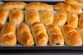 Baked yeast buns on a baking sheet