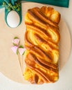 Baked yeast cake staffed with cream cheese, and white eggs close up on wooden serving board, flat lay, vertical banner. Brioche an