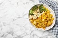 Baked yellow carrot with broccoli and cauliflowers on white marble table, top view. Space for text