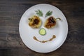 Baked yellow pepper, cucumber, green dill and french old-fashioned dijon mustard on a plate in the shape of a happy face, top view