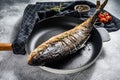 Baked Yellowtail, Japanese amberjack in a pan. Gray background. Top view