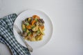 Baked young potatoes with meat and vegetables. Dark wooden background Royalty Free Stock Photo