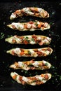 Baked zucchini boats stuffed with vegetarian sausages and cheese, seasoned with fresh herbs Royalty Free Stock Photo