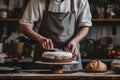 Baker adding frosting to layered cake. Baking a cake at home