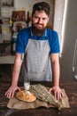 Baker against bread, wheat, milk on burlap cloth Royalty Free Stock Photo