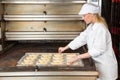 Baker in bakery with baking plate full of pretzels Royalty Free Stock Photo