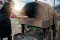 Baker bakes bread in an clay oven