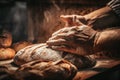 A baker baking traditional, healthy bread in a large oven. Healthy real bread produced using the traditional method.