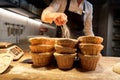 Baker with baskets for dough rising at bakery Royalty Free Stock Photo