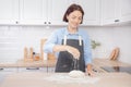 Baker chef hand sprinkling flour fresh dough on kitchen table, white background banner Royalty Free Stock Photo