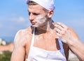 Baker concept. Cook or chef with muscular shoulders and chest covered with flour. Man on busy face wears cooking Royalty Free Stock Photo