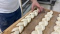 Baker creating a loaf after cutting the dough. Baker making a bread loaf. Concept baker, bakery, bread, oven. Royalty Free Stock Photo