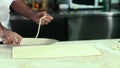 Baker cutting dough for croissants