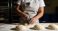 Baker cutting dough with knife on floured table, preparing bread in bakery kitchen Royalty Free Stock Photo
