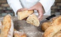 Baker cutting traditional bread french baguettes Royalty Free Stock Photo