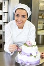 Baker decorates a cake with food dye