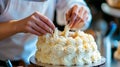 A baker decorating a cake with icing.. Royalty Free Stock Photo