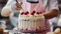 A baker decorating a cake with icing.. Royalty Free Stock Photo
