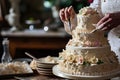 A baker decorating an elaborate wedding cake, AI generated Royalty Free Stock Photo