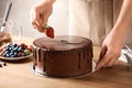 Baker decorating fresh delicious homemade chocolate